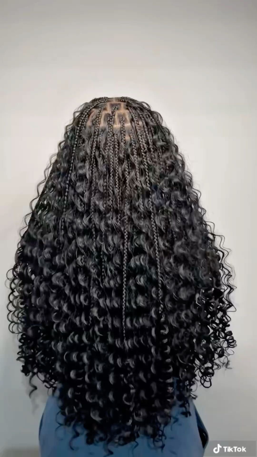 Long knotless braids with neat scalp parts, viewed from behind